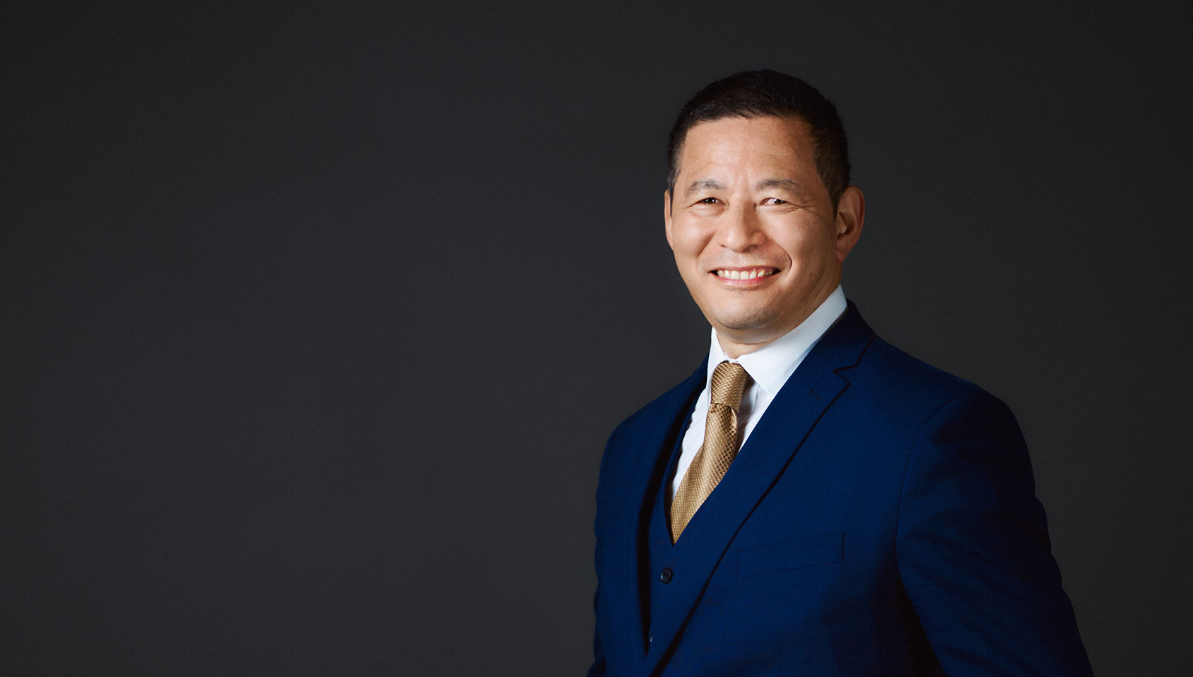 Smiling man dressed in a blue suit