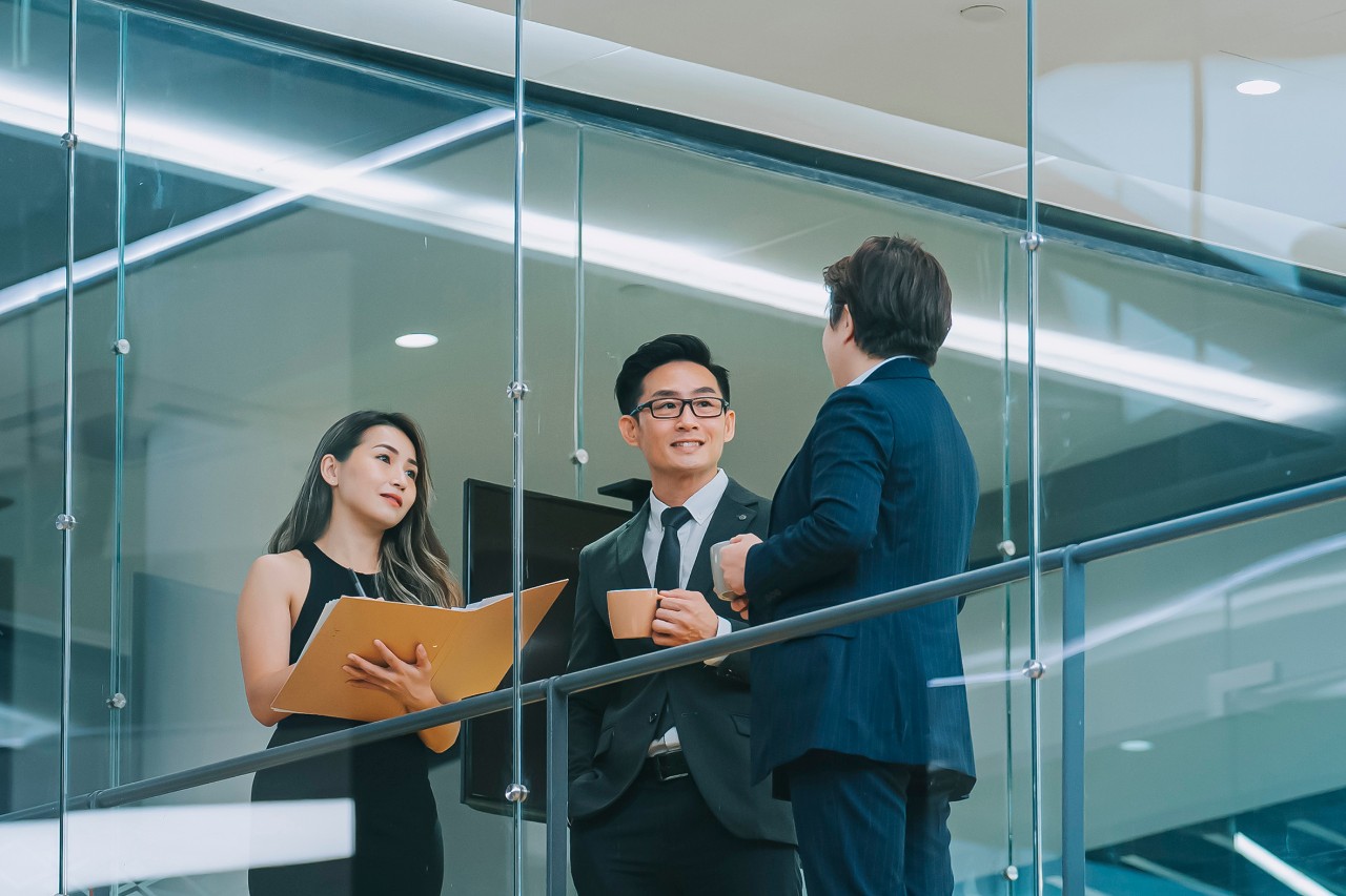 Skyscraper people Smiling businesswoman listening during team meeting in office conference room