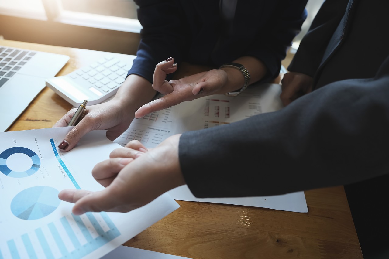 Showing papers A women business consultant describes a marketing plan to set business strategies for women business owners. business budget planning and business researching concept.